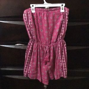 A pink dress with a no sleeve jean jacket